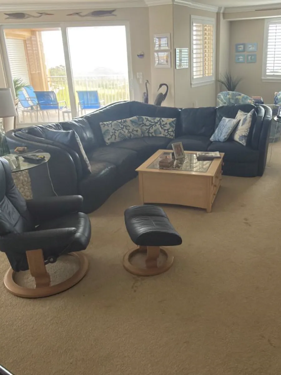 Before: worn beige carpet in an oceanfront condo living room in Ponte Vedra Beach