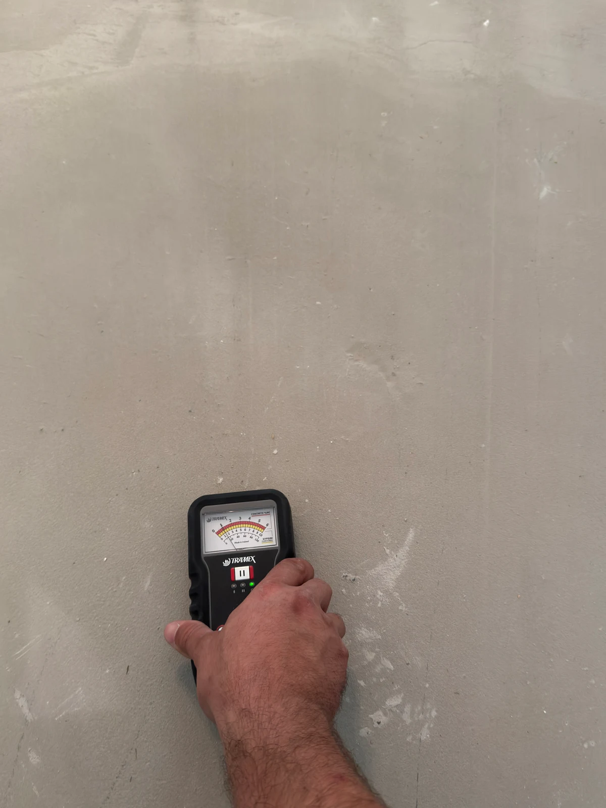 Handheld Tramex concrete moisture meter used on the exposed floor during a Nunes 4 Flooring project