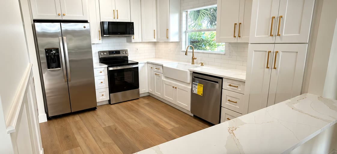 Kitchen remodel in Jacksonville, FL — white shaker cabinets, quartz countertops and new flooring by Nunes 4 Flooring