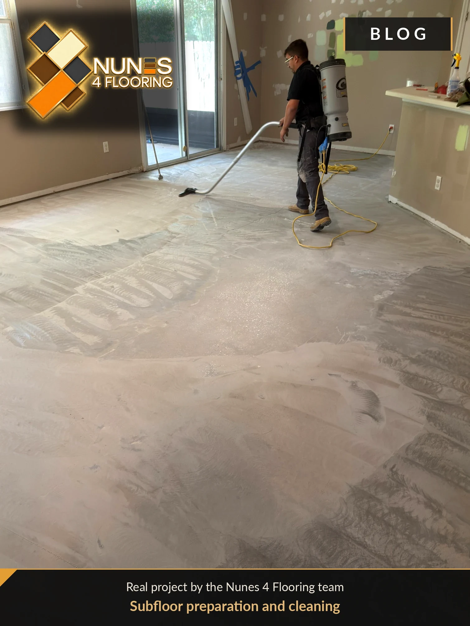 Real Nunes 4 Flooring installer using a professional vacuum to remove dust during subfloor preparation.